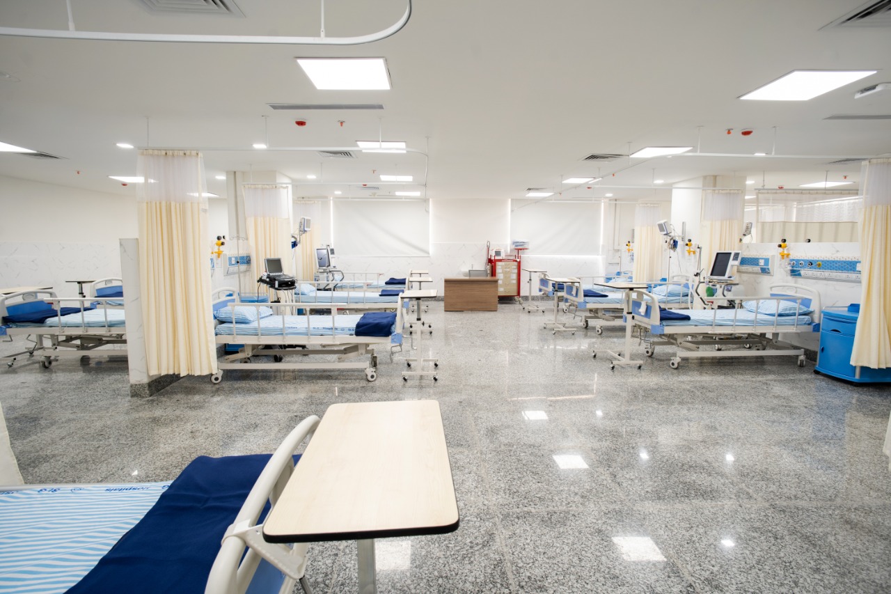 An intensive care unit at SLG Hospitals: beds in a single open ward, each with its own patient monitor and ventilator.